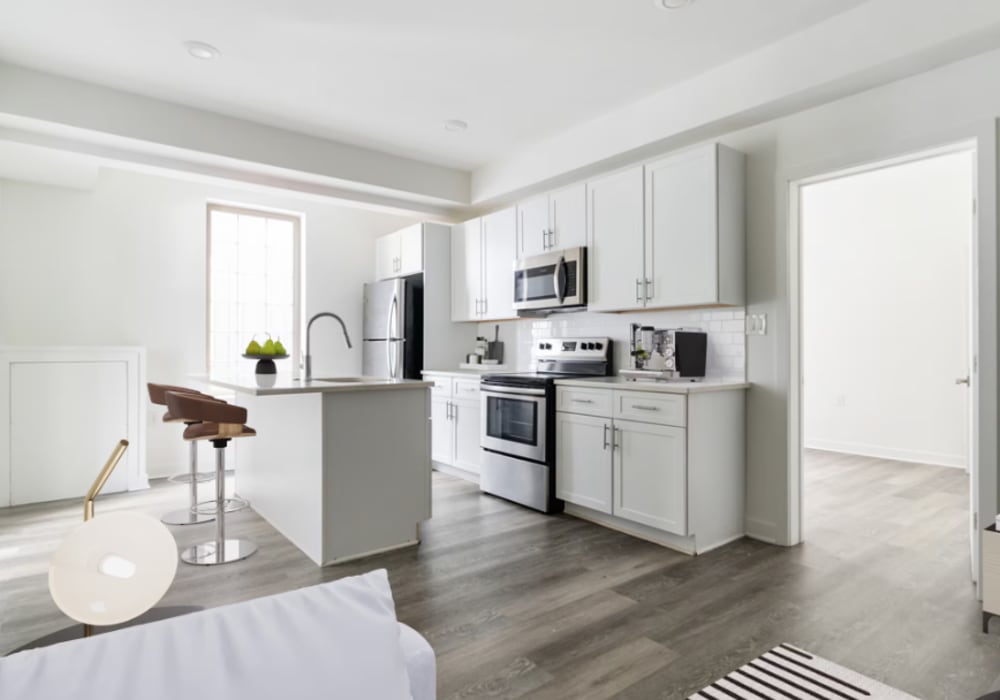 Modern kitchen with stainless steel appliances and island at Fishtown Flats in Philadelphia, Pennsylvania