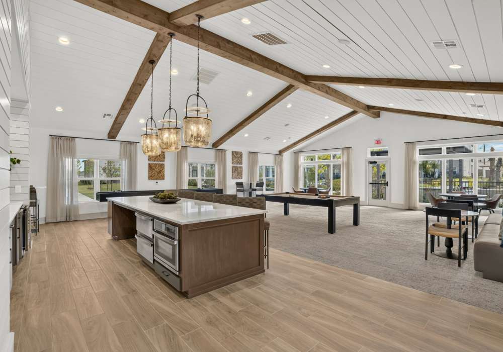 Resident lounge with kitchen and game room at Fidelis Willis.
