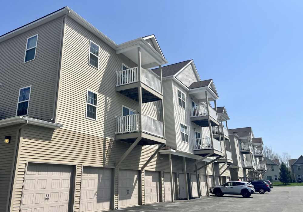  Multi-story residential building exterior with siding at Ridgeview Townhomes and Apartments in Wilton, New York
