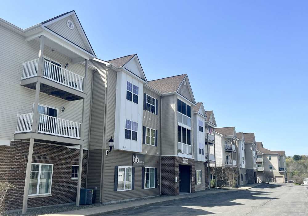 Street view of multi-story apartment exterior at Ridgeview Townhomes and Apartments in Wilton, New York