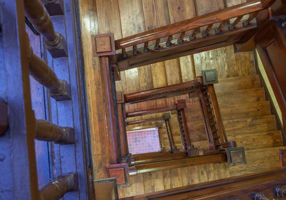 Wooden staircase with railings and steps at Hub City Lofts in Hattiesburg, Mississippi