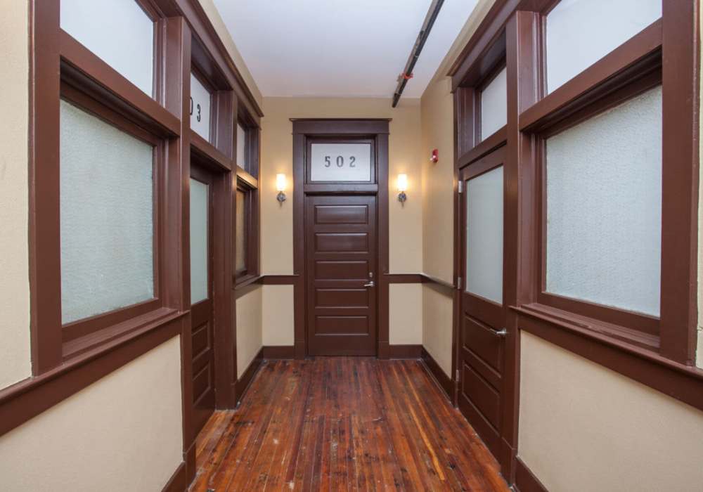 Wooden flooring in a hallway with doors at Hub City Lofts in Hattiesburg, Mississippi