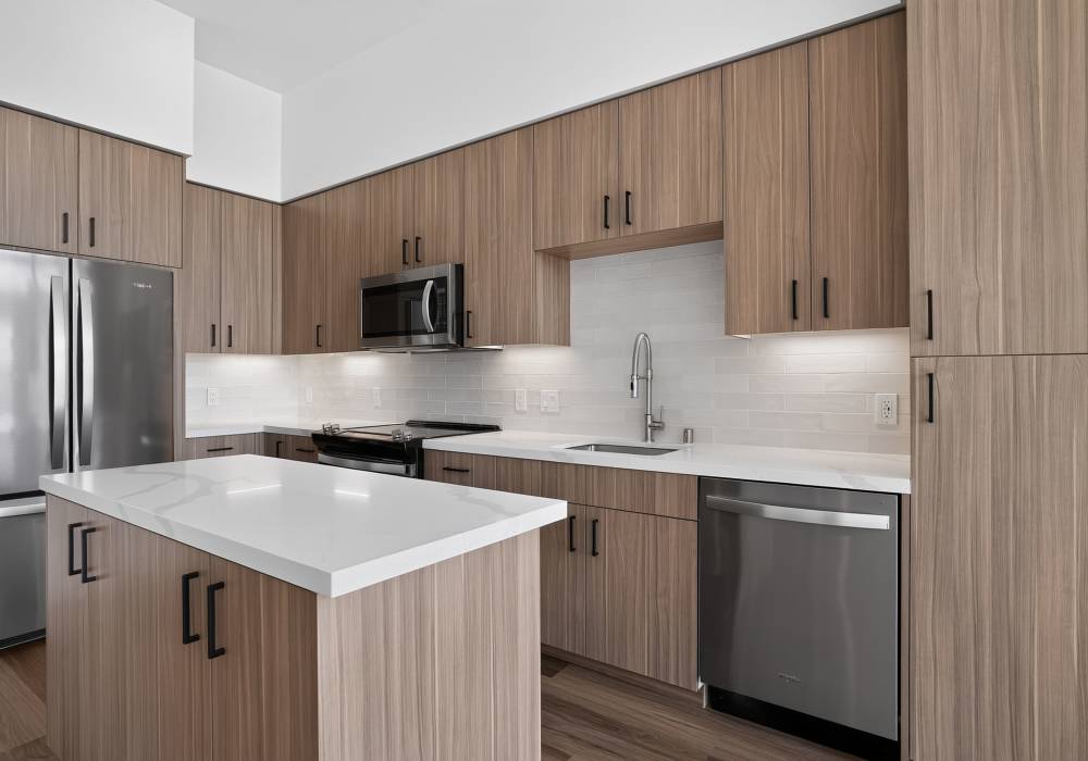 Kitchen with wood cabinets, stainless appliances and quartz island at The Colton in Redwood City, California