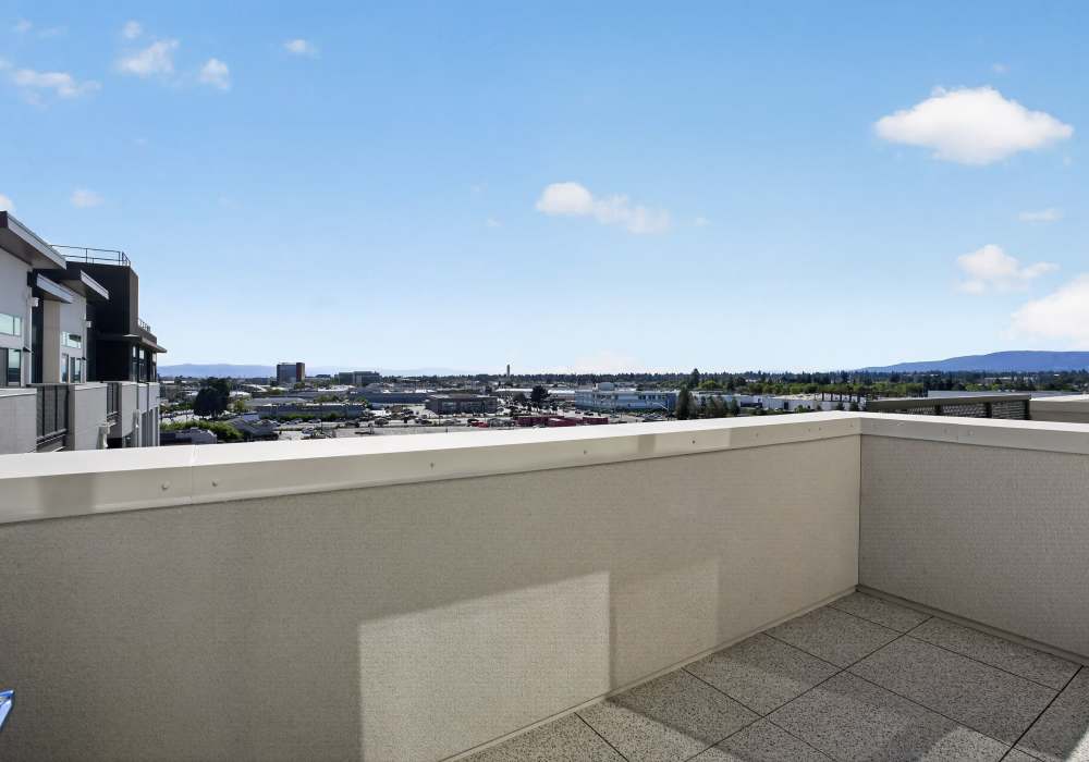 Private balcony with tile floor and open views of the surrounding area at The Colton in Redwood City, California