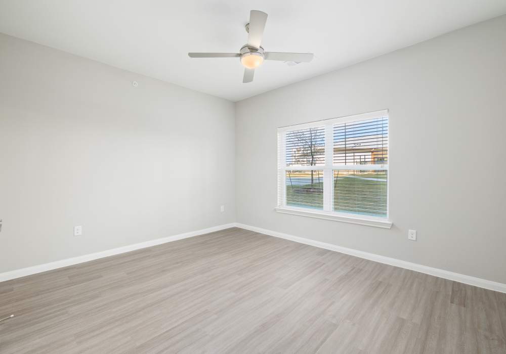 Spacious empty room with ceiling fan at Oak Creek in New Braunfels, Texas