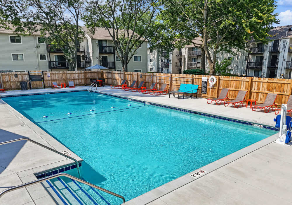 Swimming pool and apartment view with surrounded by trees at Rock Ridge Commons in Moline, Illinois
