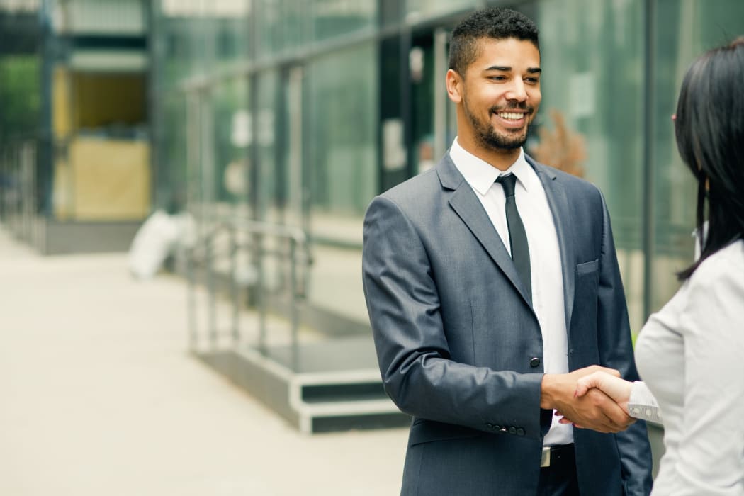 Business transaction at JMG Realty in Atlanta, GA