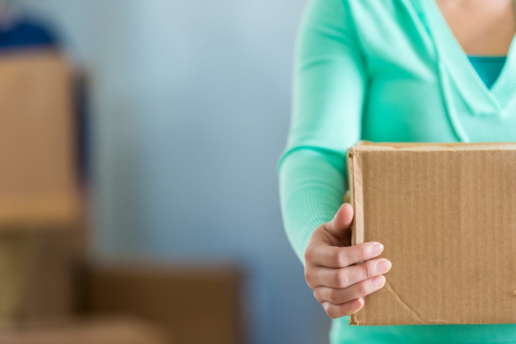 Woman moving a box at Squirrel Storage Des Moines
