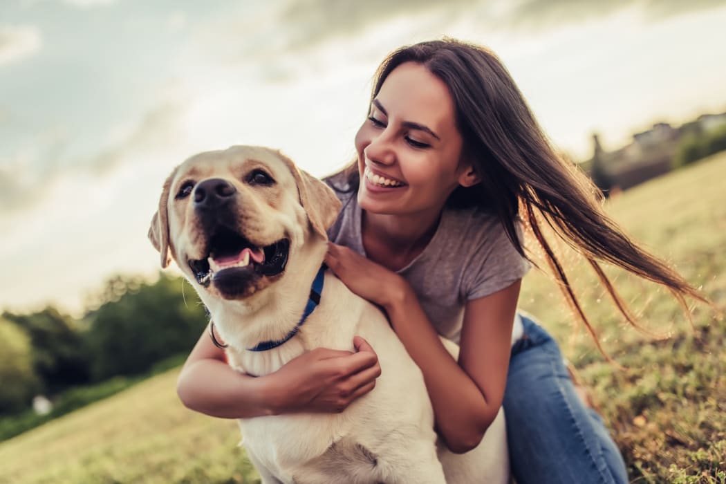 A resident playing with her dog at Cornerstone Apartments in Independence, Missouri. 