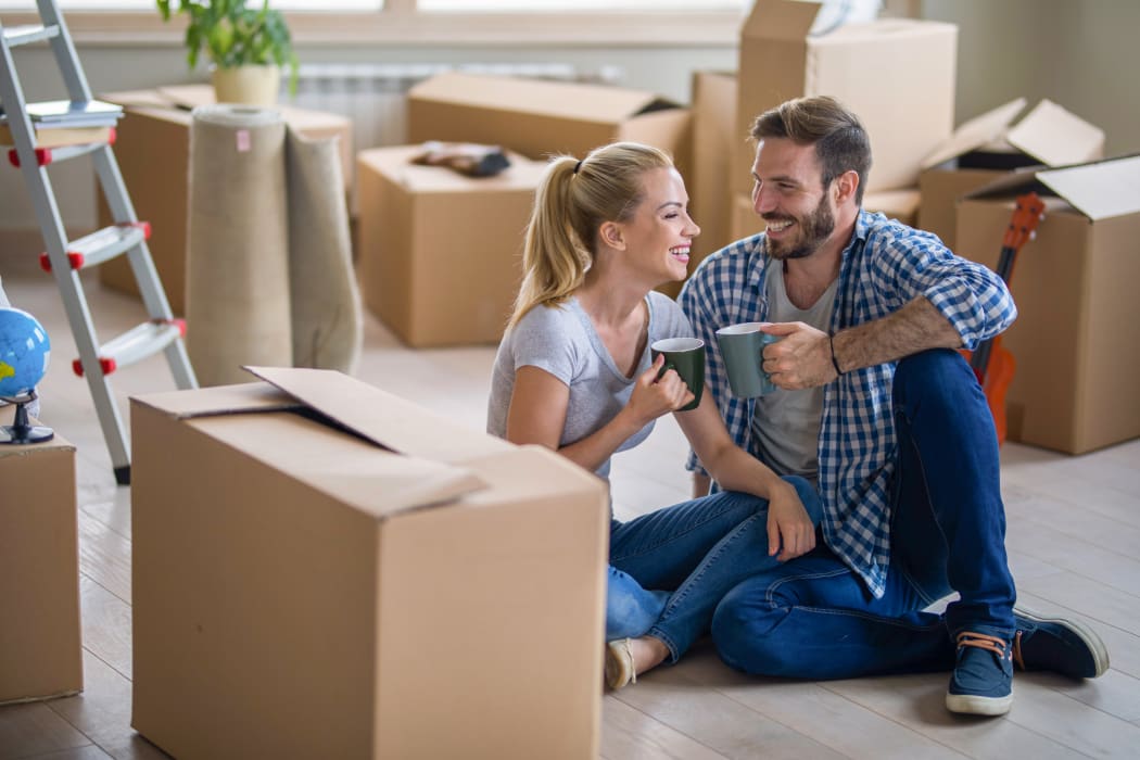 Couple enjoying some coffee after packing their belongings to be stored at Lockaway Storage in San Antonio, Texas