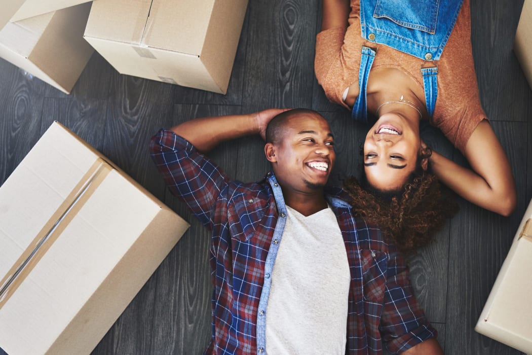 Friends laying on the floor after they finished packing their belongings to be stored at Lockaway Storage in Boerne, Texas
