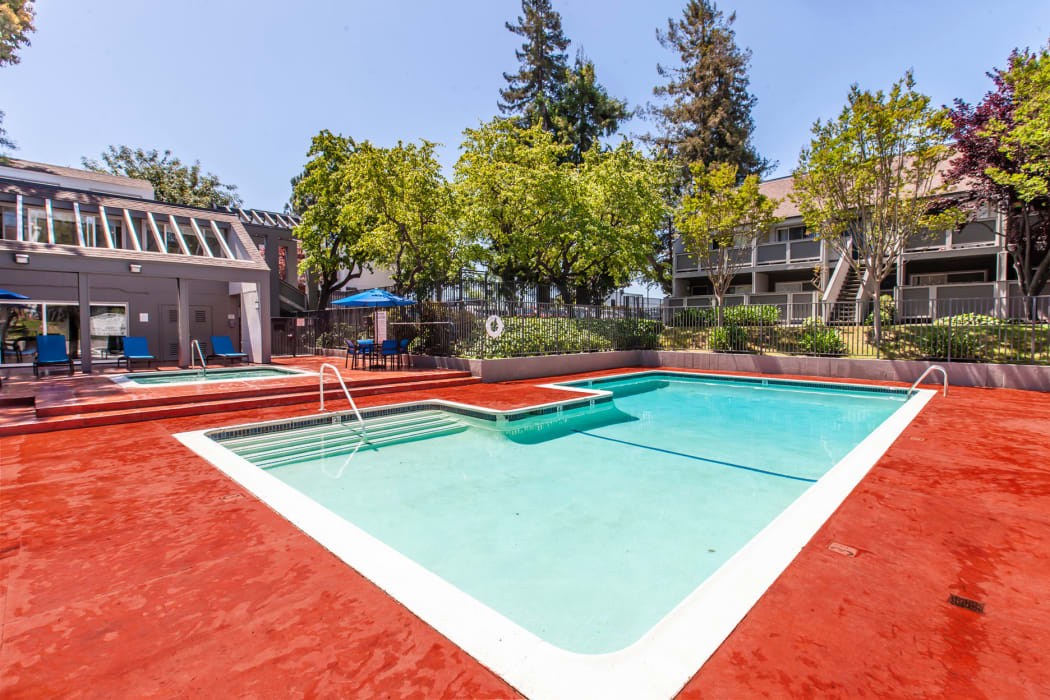 pool and lounge areas at The Timbers Apartments in Hayward
