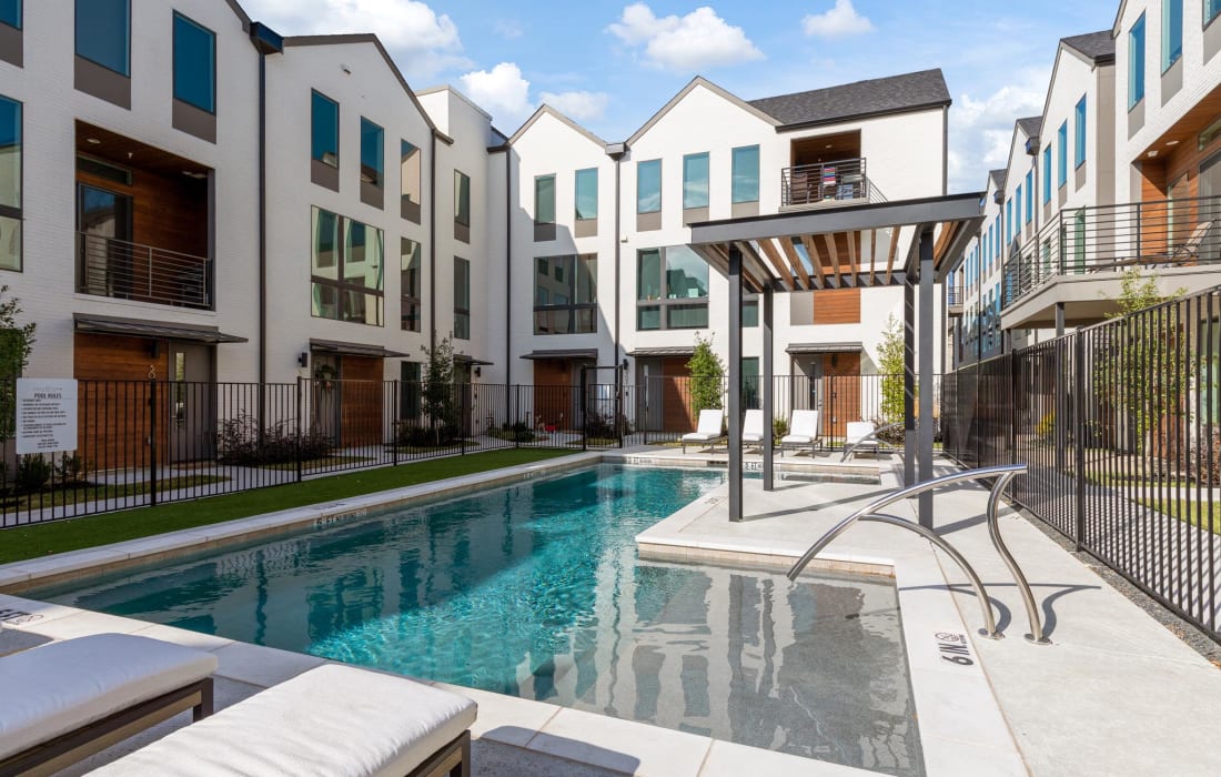 Exterior and resident swimming pool at The Collection Townhomes in Dallas, Texas