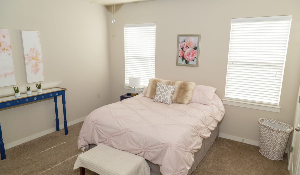 A large bedroom with two windows at Traditions at Mid Rivers in Cottleville, Missouri