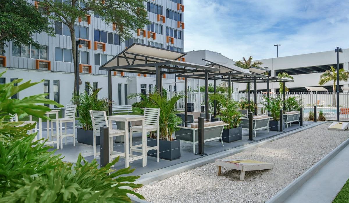 Shaded seating near the bocce ball and cornhole court at Our Property in St Petersburg, Florida