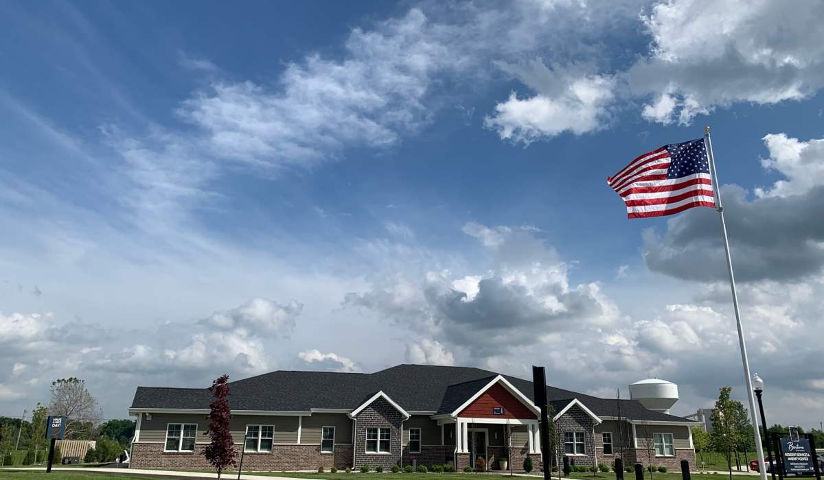 Clubhouse with an American Flag outside at Bonterra Apartments in Fort Wayne, Indiana