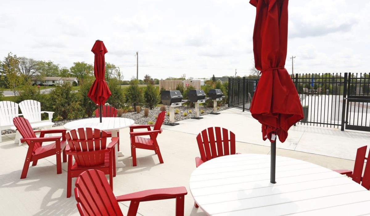 Patio tables with umbrellas at Bonterra Apartments in Fort Wayne, Indiana