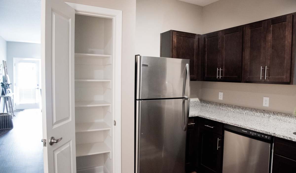 Kitchen with a built in storage pantry at Bonterra Apartments in Fort Wayne, Indiana
