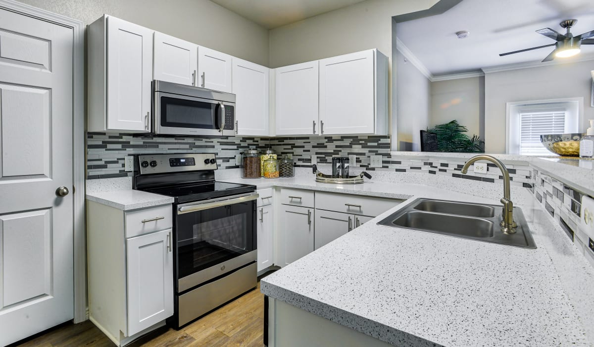 Lots of counter space in the kitchen with stainless steel appliances at Bella Springs Apartments in Colorado Springs, Colorado
