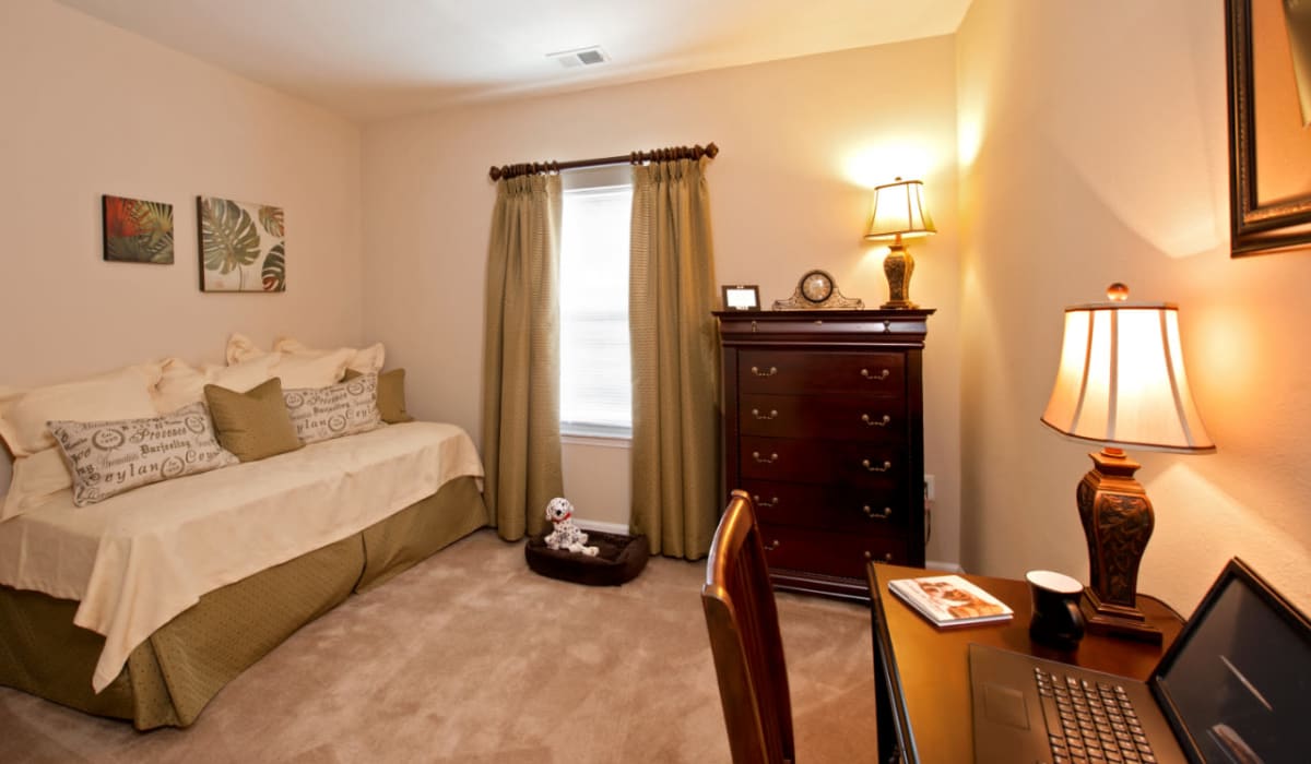 A spacious bedroom with a window at Meridian Watermark in North Chesterfield, Virginia