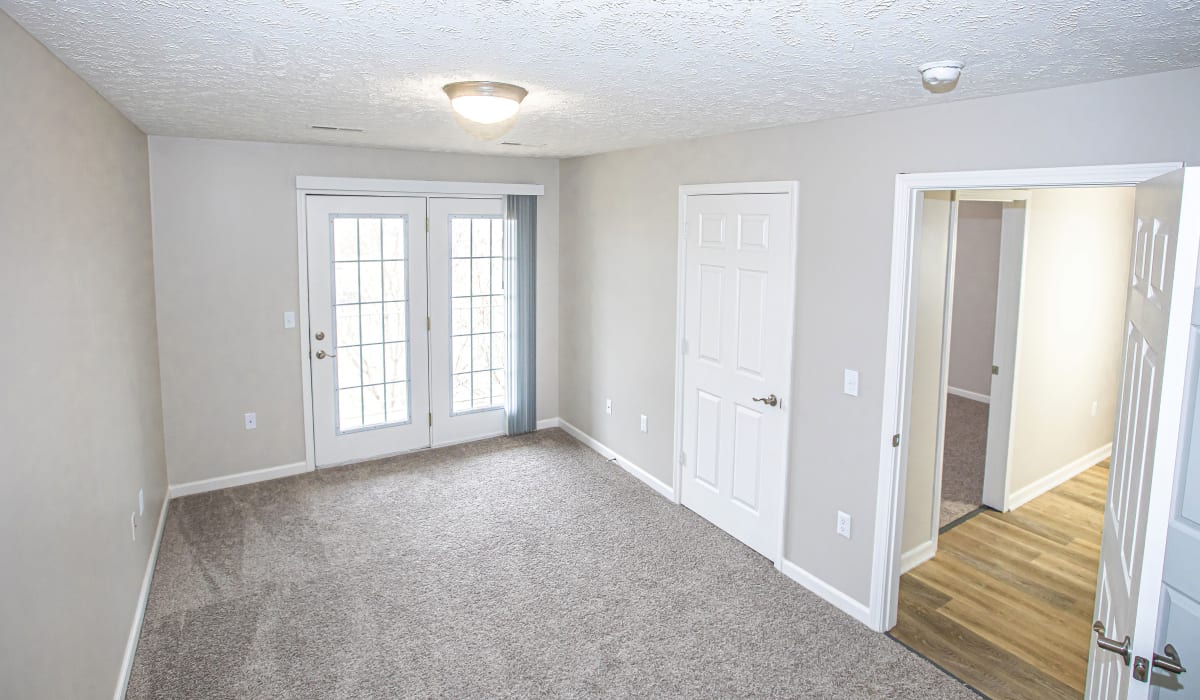 A bedroom with patio access at Silver Lake Hills in Fenton, Michigan