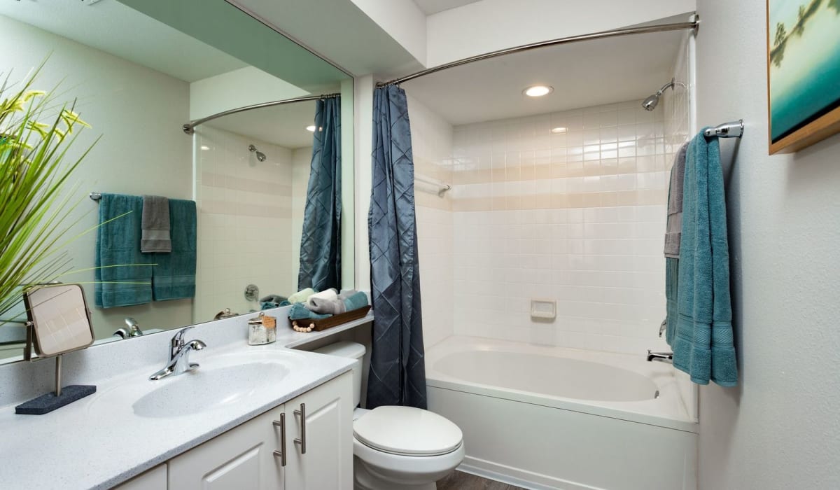 Bathroom with blue shower curtain at Evergreen Commons in Union City, Georgia