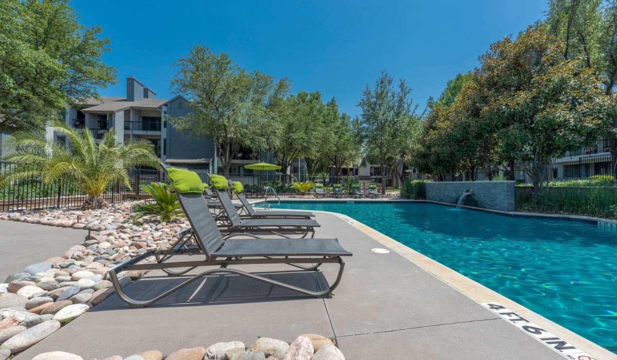 Pool with chairs at Gardens of Valley Ranch in Irving, Texas