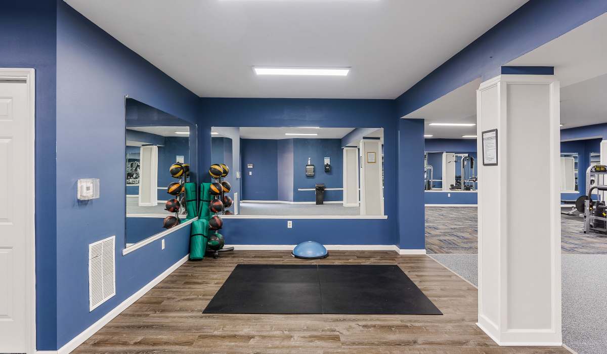 Fitness center with wood-style flooring at Burlington Oaks in Burlington, Kentucky
