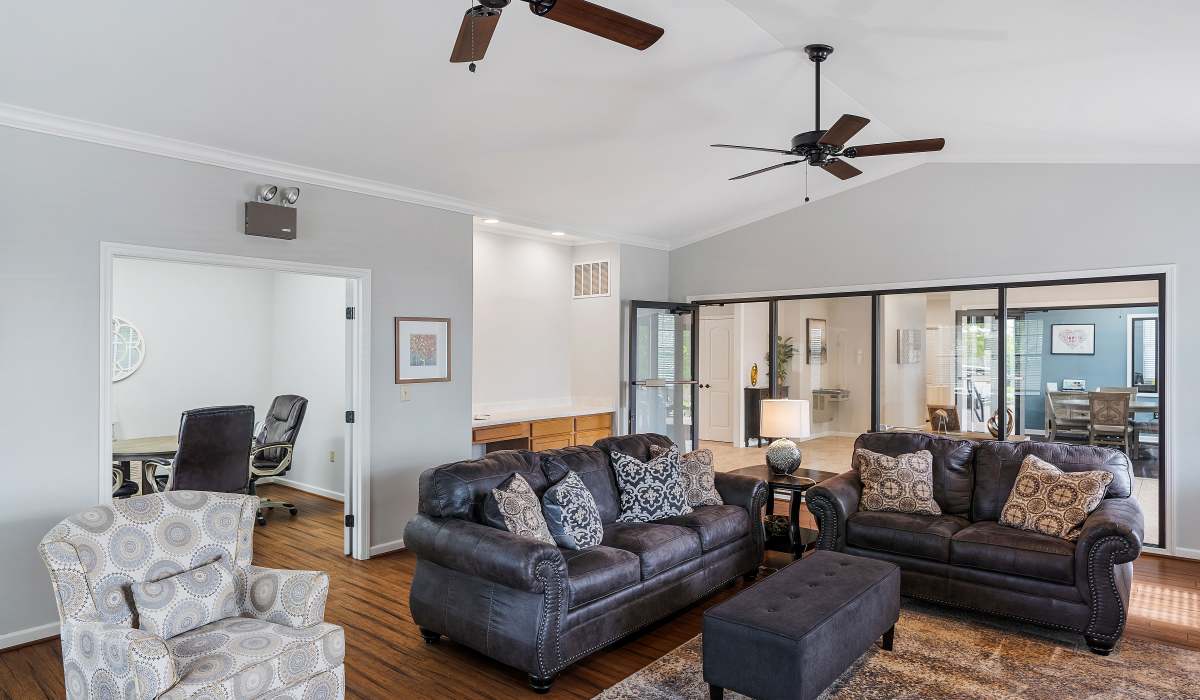 Spacious community living room with wood-style flooring at Burlington Oaks in Burlington, Kentucky