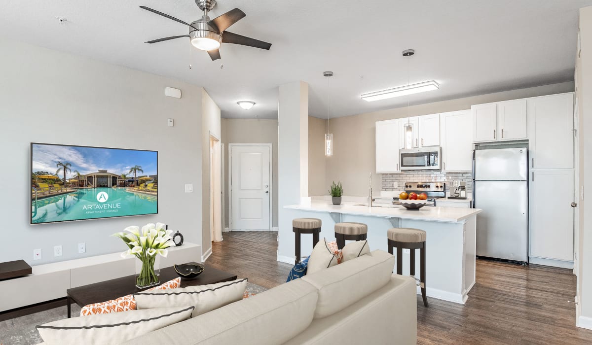 Living room and kitchen at Art Avenue Apartment Homes in Orlando, Florida