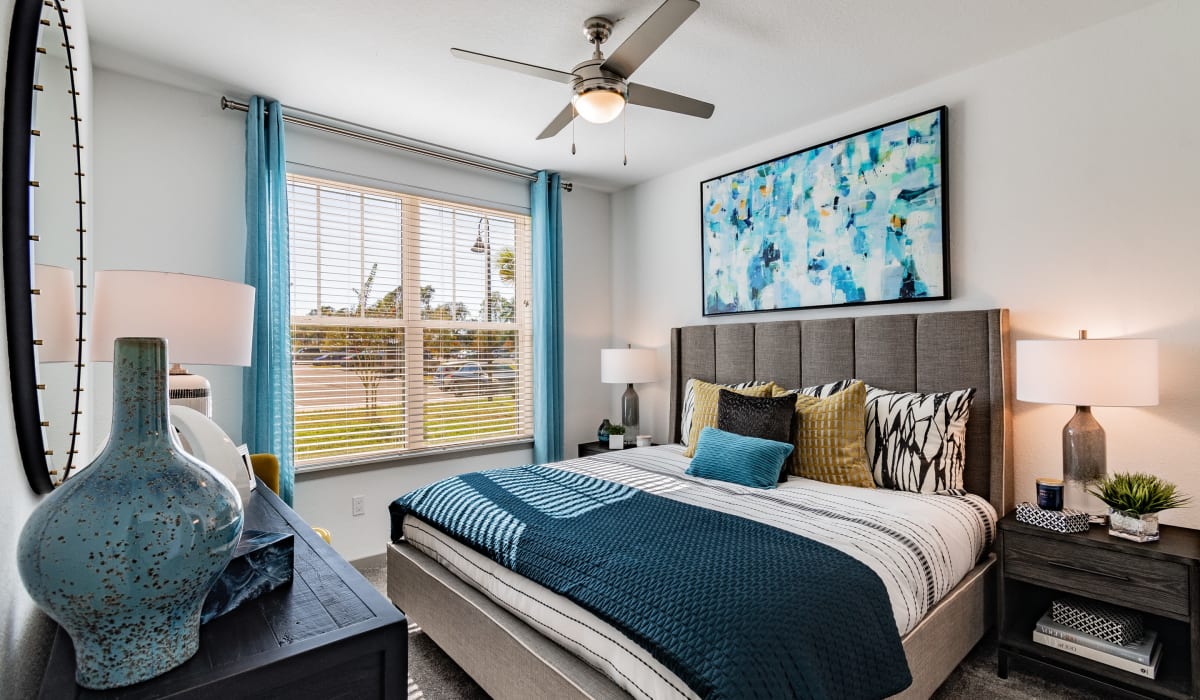Spacious bedroom with window and ceiling fan at Vue on Lake Monroe in Sanford, Florida