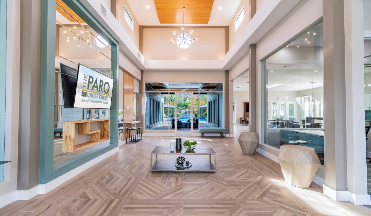 Resident common area with leather seating and trendy neon lights at The Parq at Cross Creek in Tampa, Florida
