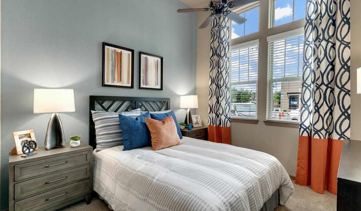 Spacious bedroom with window and ceiling fan at Station House at Lake Mary in Lake Mary, Florida