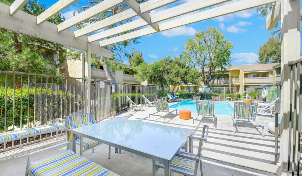 Lounge by our luxurious pool at Torrey Pines Apartment Homes in West Covina, California