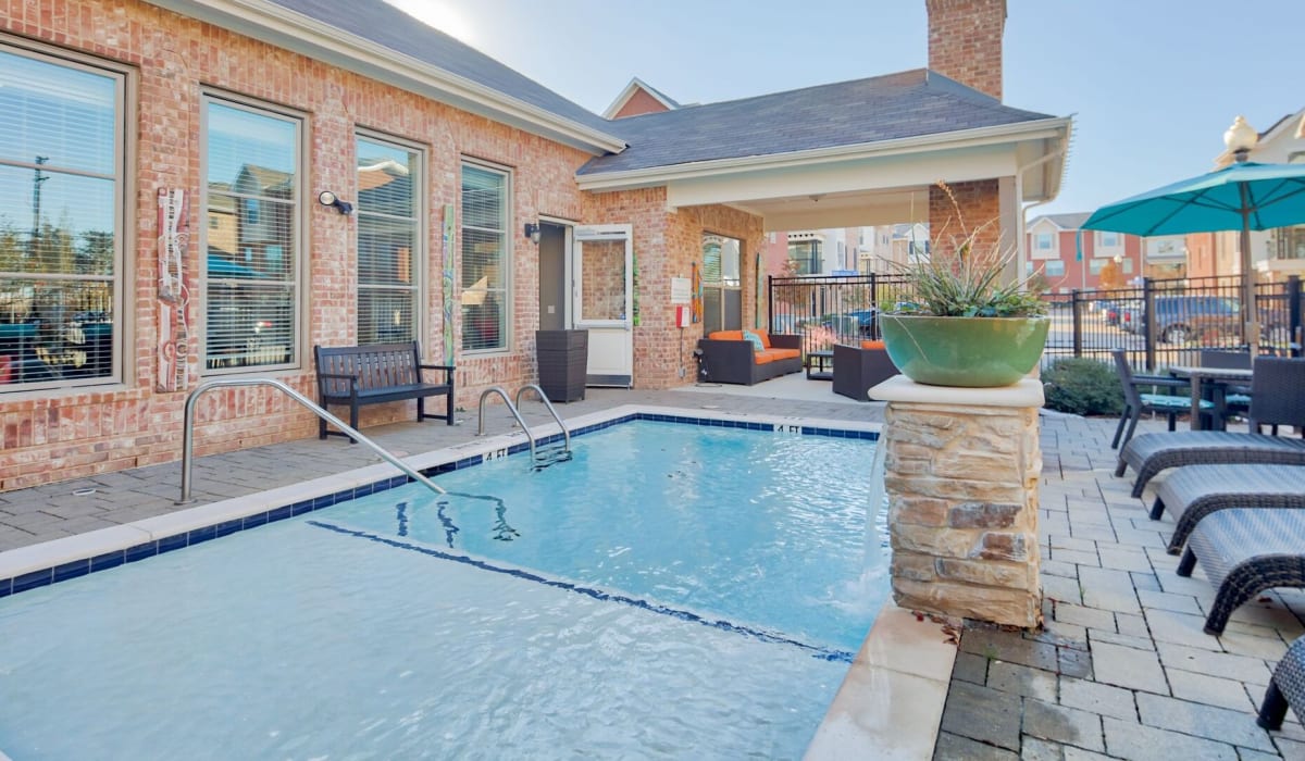 Swimming pool with lounge chairs at Parkside Towns in Richardson, Texas
