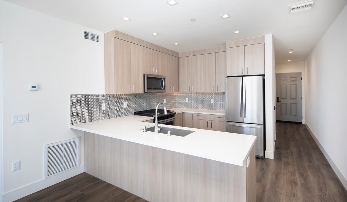 Wood-style flooring and modern kitchen at Mission West Lofts in San Diego, California