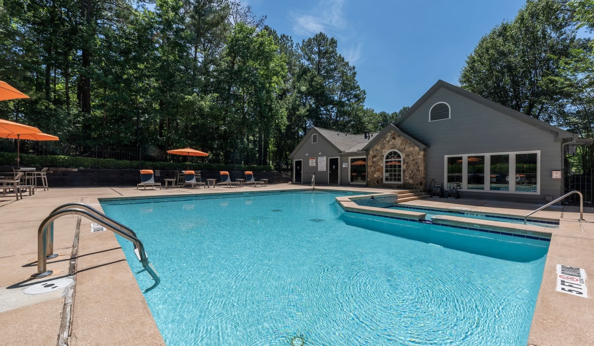 Pool with large umbrellas at Reserve at Garden Lake in Riverdale, Georgia