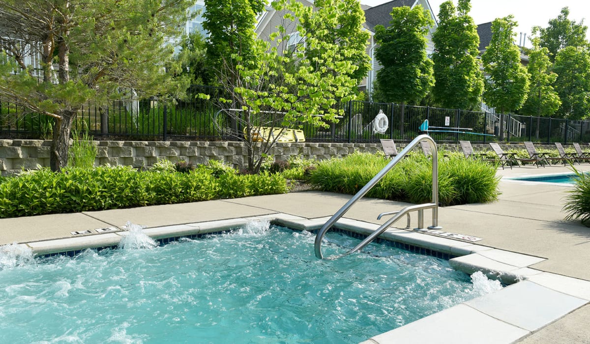Hot tub with nice greenery around at Encore Townhomes in Utica, Michigan