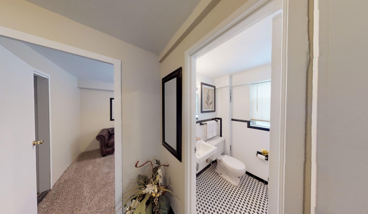 Bathroom with big mirror  at Rugby Square Apartments in Syracuse, New York