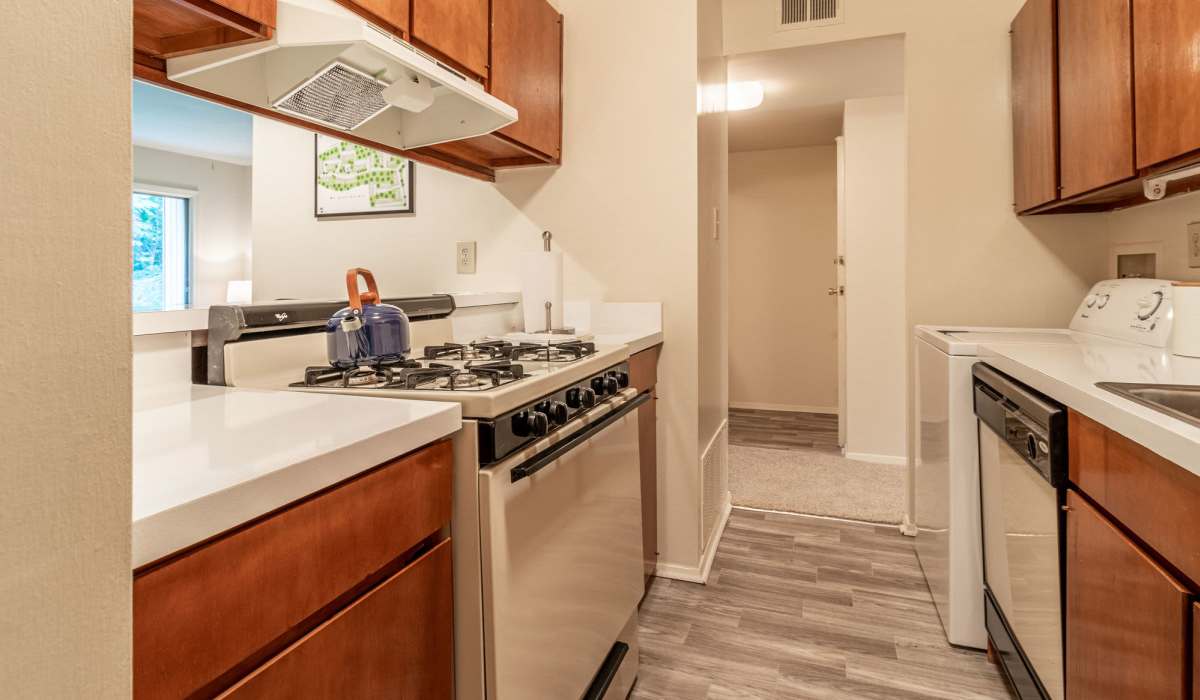 Kitchen with wooden cabinetry at Willow Oaks Apartments in Richmond, Virginia