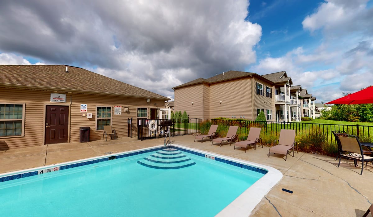 Swimming pool with lounge chair at Park Lane South Apartments in Depew, New York