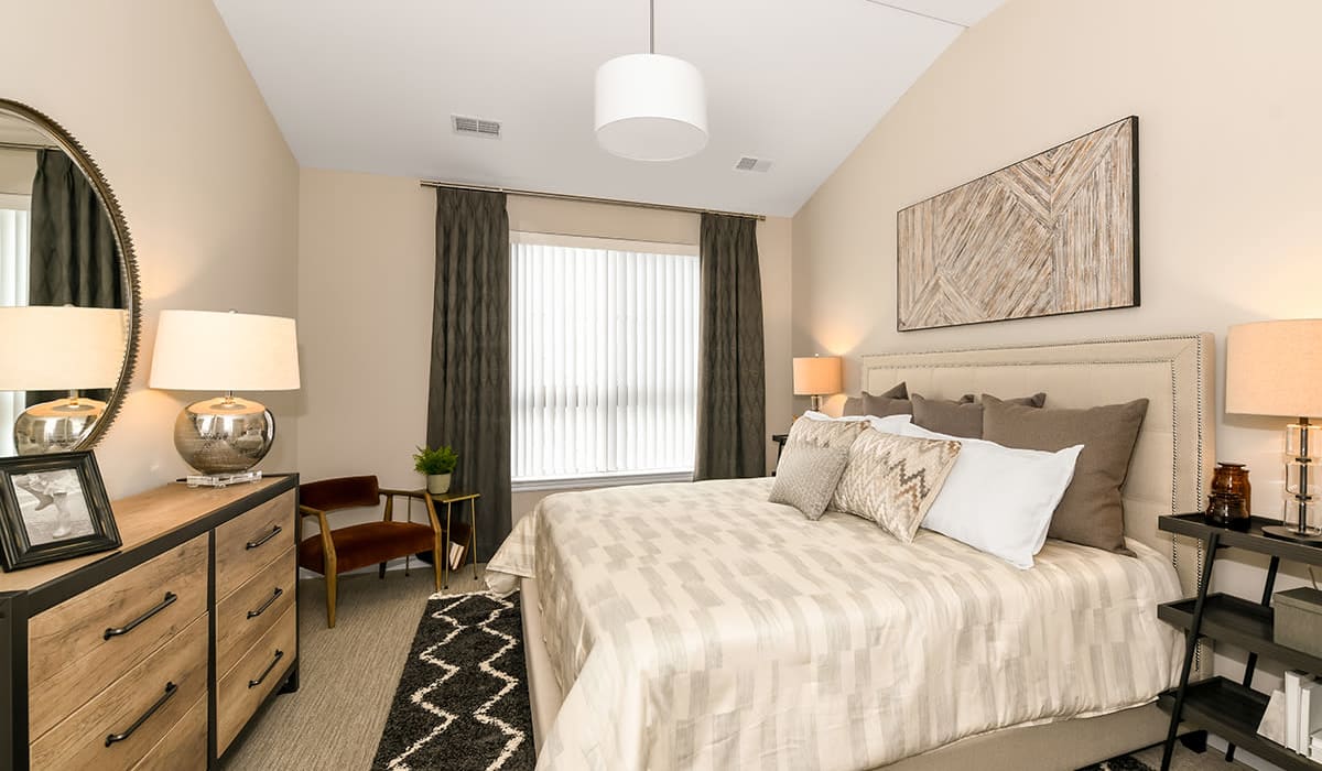 Bedroom with large windows at Encore at Manchester in Novi, Michigan