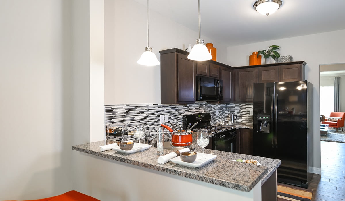 Kitchen with bar area at Encore Townhomes in Utica, Michigan