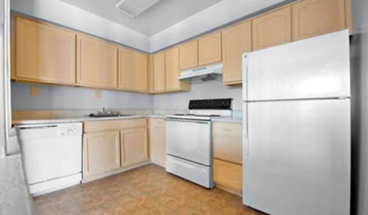 Apartment kitchen with stainless steel finishes at Towne Crest in Gaithersburg, Maryland