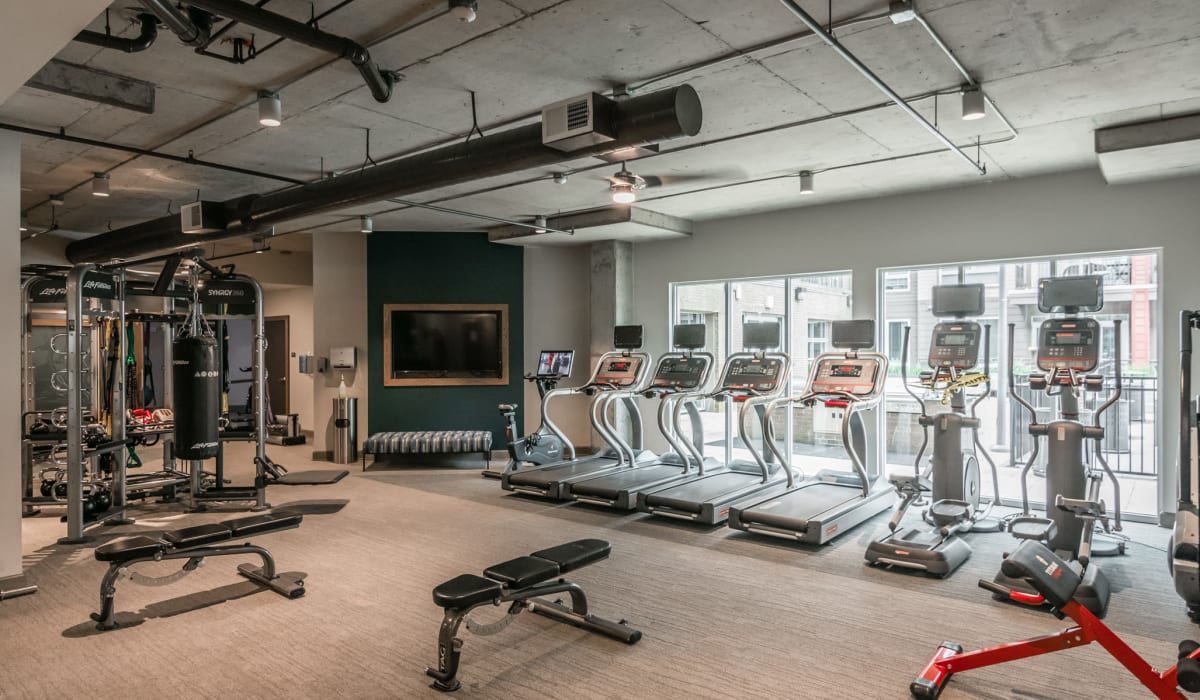 Modern gym fitness room with large windows and treadmills at The Guthrie North Gulch in Nashville, Tennessee