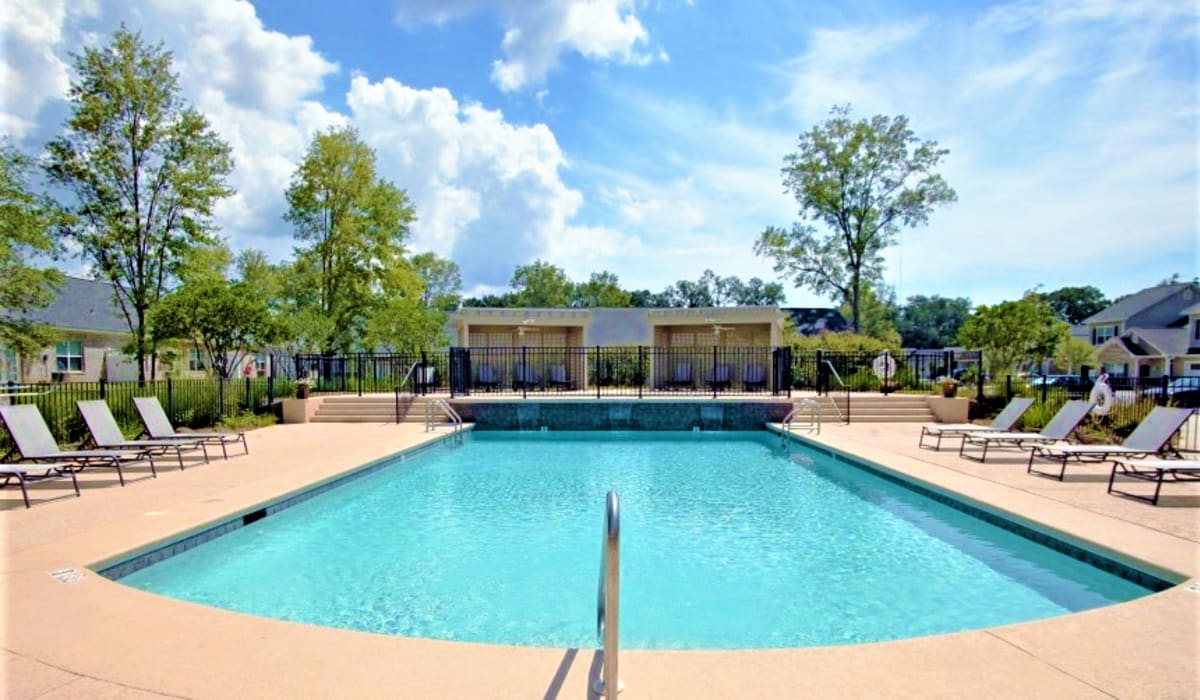 Our swimming pool with lounge chairs at The Atrium in Daphne, Alabama