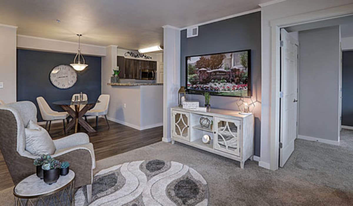 Model living room with a round rug at La Serena at Hansen Park in Kennewick, Washington