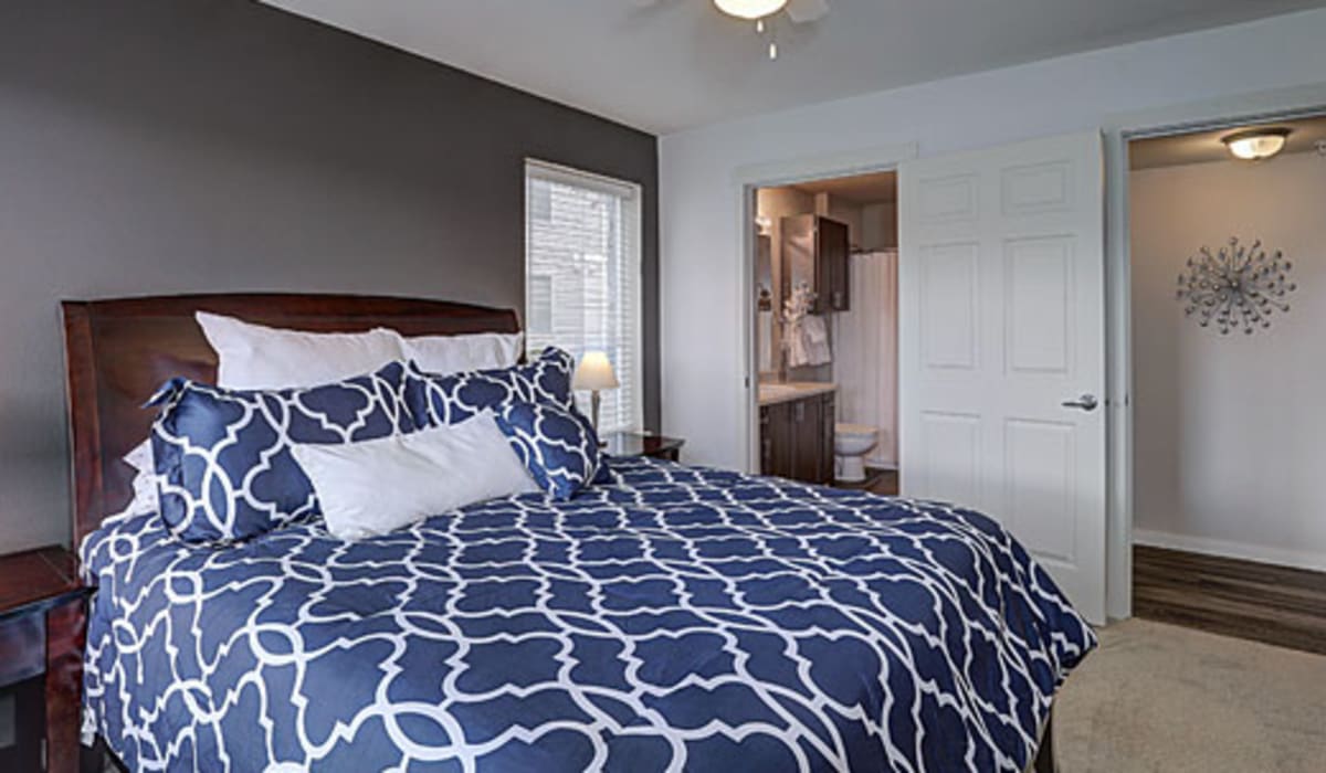 Model bedroom with blue bed sheets at La Serena at Hansen Park in Kennewick, Washington