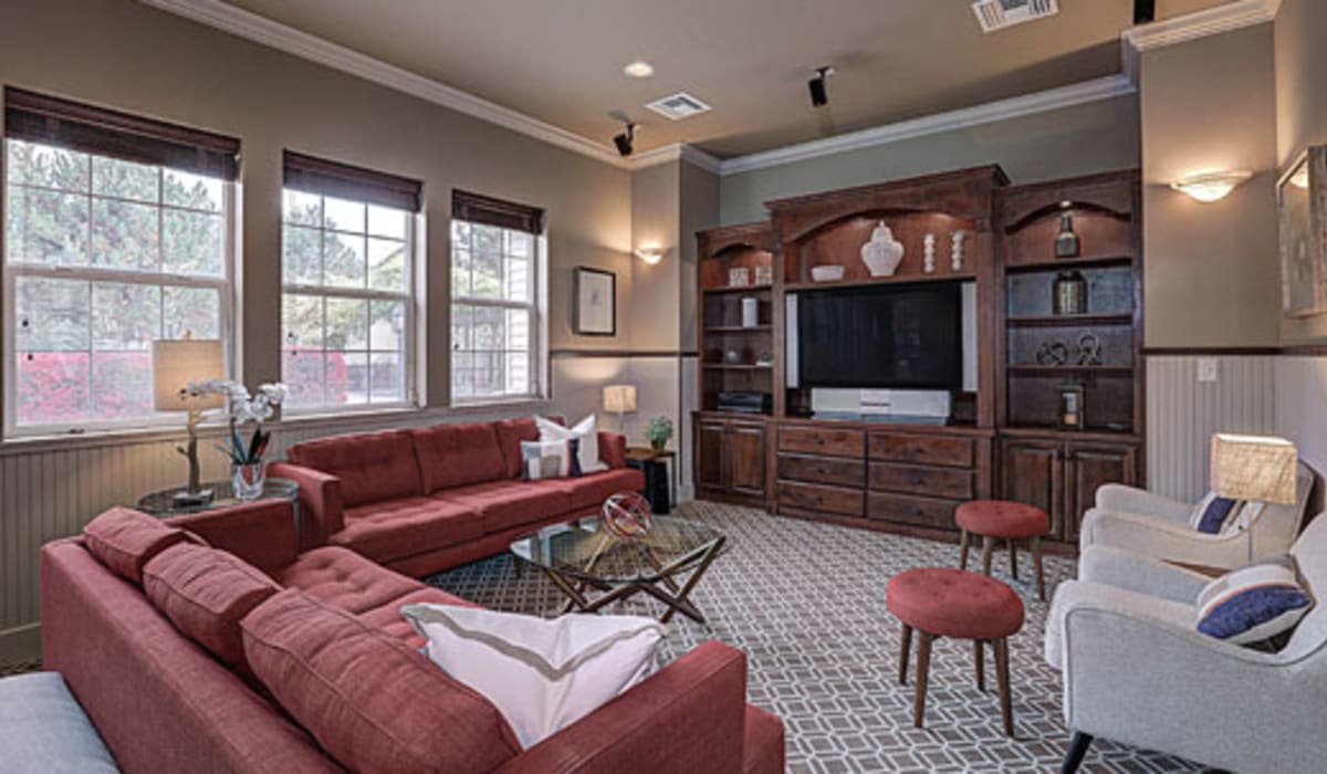Model living room with a red couch at La Serena at Hansen Park in Kennewick, Washington