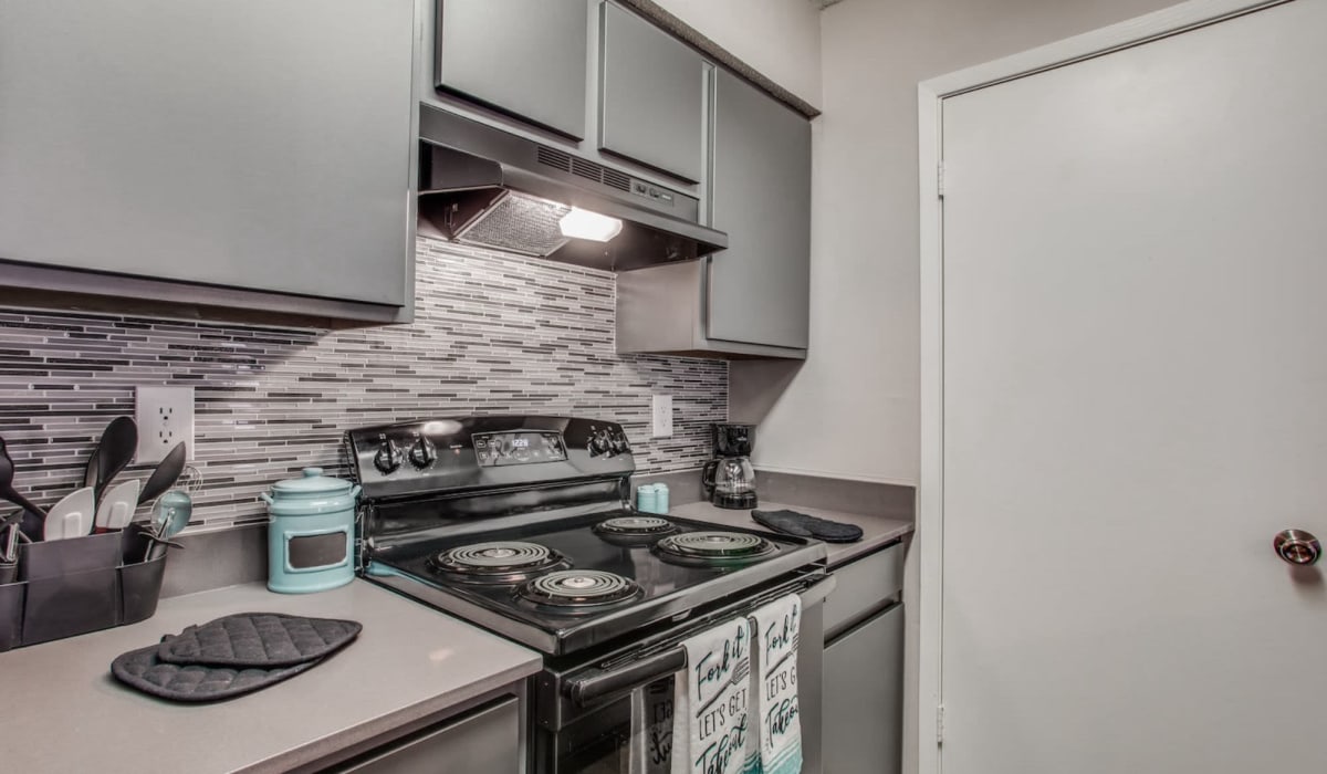 Kitchen with modern backsplash at Athena Apartment Homes in Benbrook, Texas